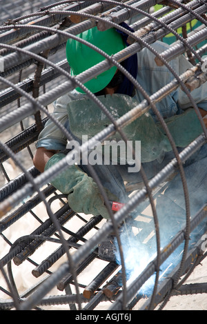 welder working on rebar for reinforced concrete on a construction site in abu dhabi united arab emirates Stock Photo
