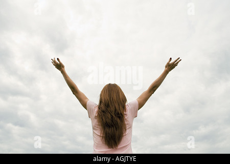 Woman worshipping with open arms Stock Photo