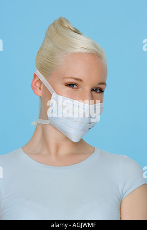 Young woman wearing a surgical mask Stock Photo