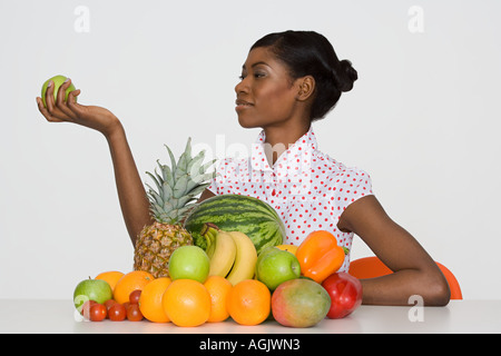 Young woman holding an apple Stock Photo