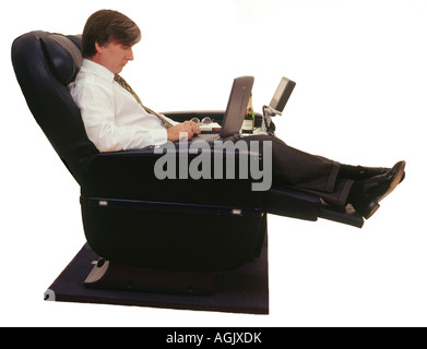 Businessman Traveling with Laptop in Premium Class seat Stock Photo