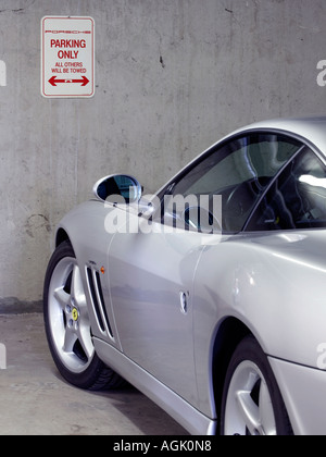 silver Ferrari 550 Maranello parked in a Porsche parking only zone Stock Photo