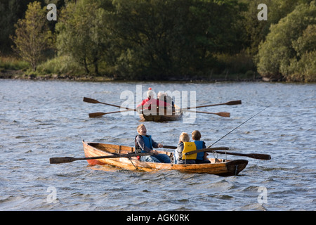 Derwentwater Keswick Cumbria UK boys fishing from rowing boats Stock Photo