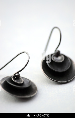 Earrings made of domed sterling discs. Stock Photo