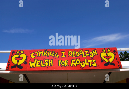 WELSH FOR ADULTS bilingual Welsh English language sign at the National Eisteddfod of Wales Stock Photo