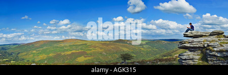 Young man reading a book in the countryside Devon UK Stock Photo