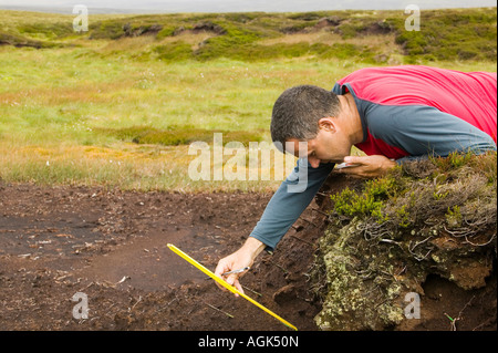 Dr Jeff Warburton of Durham University measuring peat erosion in the North Pennines, Cumbria, UK Stock Photo