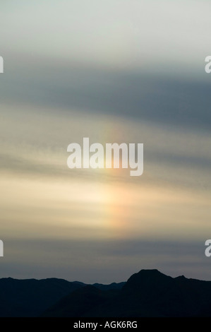 Parhelion or sun dog over the Langdale Pikes, Lake District, UK Stock Photo