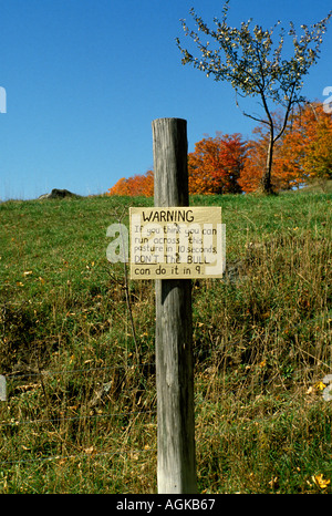 Humorous warning sign in field Vermont United States of America USA Stock Photo