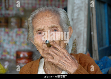 Myanmar Bagan Popa mountain park old woman smoking a cigar Stock Photo