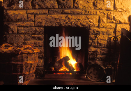 Fireplace with roaring fire Stock Photo