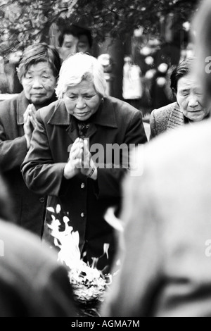 Old Women Praying with Incense Stock Photo