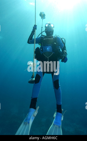 Woman diver doing safety stop at Rich s Well divesite Bahamas Stock Photo