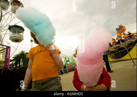 Children eating candyfloss at the funfair Stock Photo