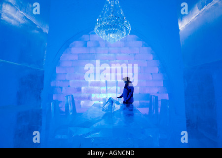 A person at a dinner table ice sculpture inside the Ice hotel Jukkasjarvi Sweden Stock Photo