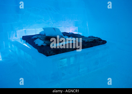 Bed with reindeer skin in a hotel room at the Ice hotel Jukkasjarvi Sweden Stock Photo