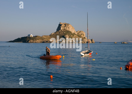 dh Kastri Island KASTRI ISLAND GREECE KOS Girl in motor boat Monastery of Ayios Antonis Kamari Bay Stock Photo
