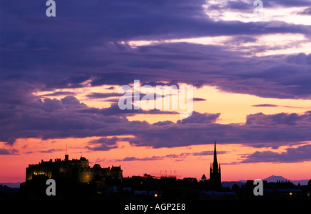 Blue pink and orange sky and cloud over the silhouette of Edinburgh Castle photographed during a beautiful summer sunset. Stock Photo