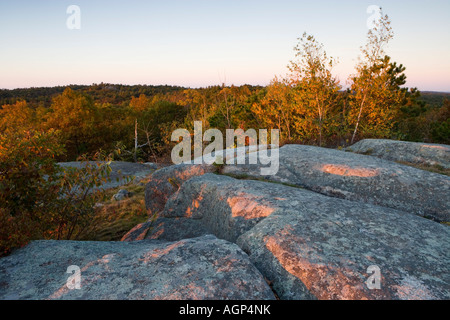 Early morning light on the granite on Sunset Rock in Gloucester Massachusetts Stock Photo