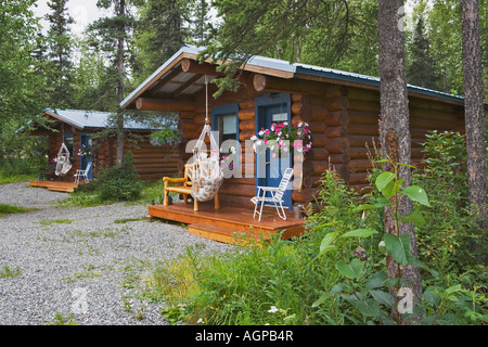 USA, Alaska, Palmer. Log cabins nestled among trees near Hatcher Pass. Stock Photo