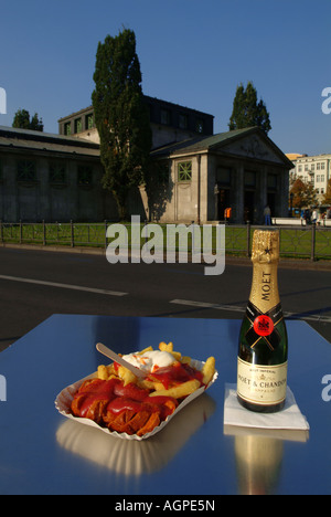 Currywurst and French fries with sauce in plate. Berlin delicacy. Fast food. Berlin. Wittenbergplatz. Stock Photo