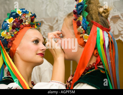 Two members of the folk dance group Bessarabskij Souvenir are busy with their make up before a performance Stock Photo