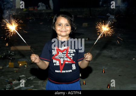 HMA79949 Indian girl holding fire cracker in her hand on Diwali Festival of lights in India Model Released Stock Photo