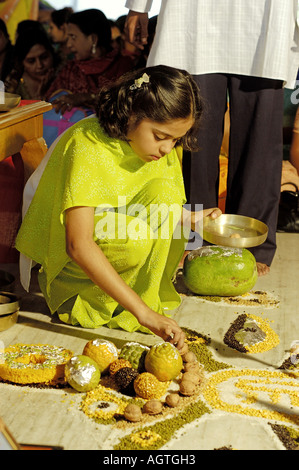 HMA79960 Girl offering fruit on special prayer by Jain religious community in India Stock Photo