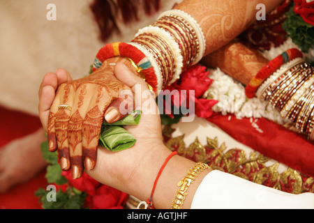 Indian Gujarati wedding Hastmelap ritual the brides father gives daughters hand in hand of groom in marriage Stock Photo