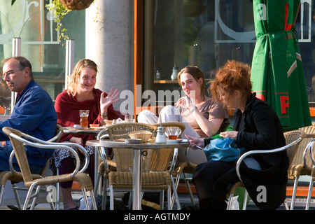 People dine at an outdoor cafe in Amsterdam Netherlands Stock Photo