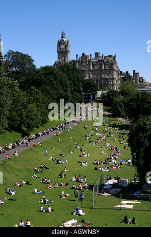 People enjoying hot weather in the park at Princes Street Gardens, Edinburgh, Scotland Stock Photo