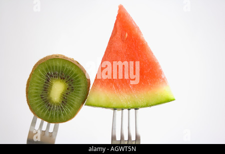 Piece of kiwi fruit and water melon on forks Stock Photo