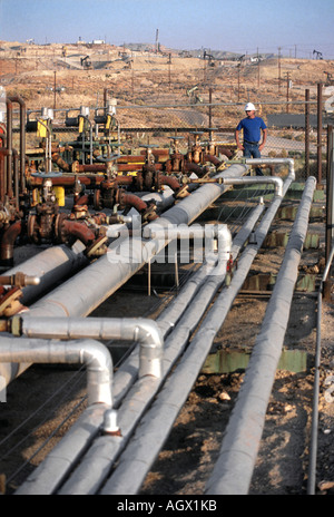 Worker in oil lines in Taft California Stock Photo