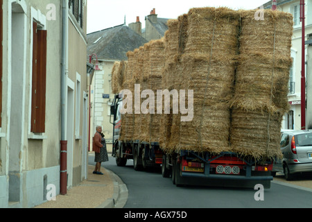 Flat Platform Lorry and trailer fully laden carrying a load bales of straw France EU Europe Stock Photo