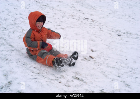 MR Fife year old boy sliding down a slope Stock Photo