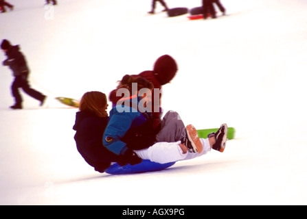 On a snowy day in early December, the kids were out at a local park in Salt Lake City, Utah, sledding and enjoying the winter. Stock Photo