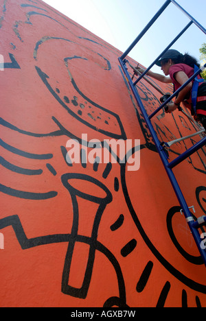 Workers restore the famous Keith Haring Crack is Wack mural in Harlem River Park in NYC The mural was originally painted in 1986 Stock Photo