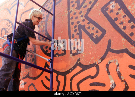 Workers restore the famous Keith Haring Crack is Wack mural in Harlem River Park in NYC The mural was originally painted in 1986 Stock Photo