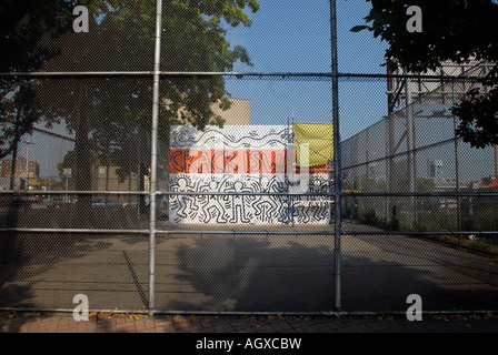 Workers restore the famous Keith Haring Crack is Wack mural in Harlem River Park in NYC The mural was originally painted in 1986 Stock Photo