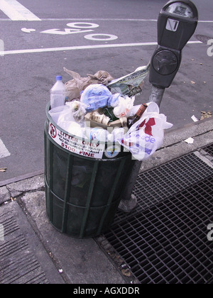 Trash can full, overflowing on the sidewalk in New York City color photograph Stock Photo