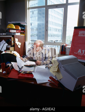 FLUSTERED BUSINESS MAN IN OFFICE SMALL BUSINESS Stock Photo