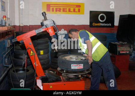 A   Man At Work At A Tyre Centre. Stock Photo