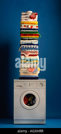 pile of ironed laundry on top of washing machine Stock Photo
