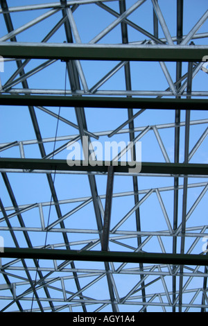 A framework of structural steel is constructed to support a wall in a ...