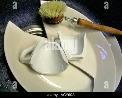 broken crockery in a sink Stock Photo