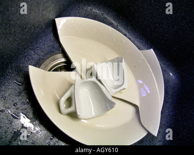 broken crockery in a sink Stock Photo