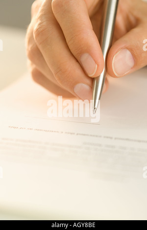 Man signing a document Stock Photo