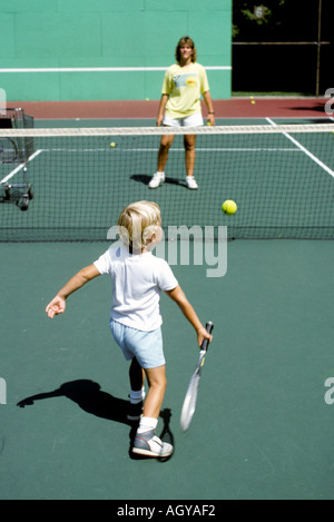 4 year old boy takes tennis lessons Stock Photo