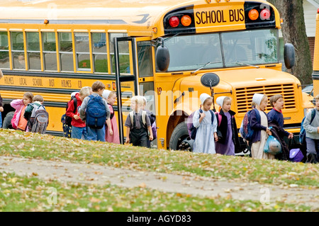 Amish life in Millersburg and Sugar Creek Holms County Ohio School children boarding a school bus Stock Photo