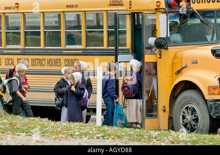 Amish life in Millersburg and Sugar Creek Holms County Ohio School children boarding a school bus Stock Photo